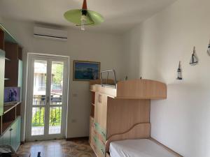 a bedroom with a bed and a cabinet and a window at Casetta al mare MariaTeresa in Nocera Terinese