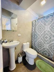 a bathroom with a white toilet and a sink at TATA Hotel Boutique in Cusco +34 photos