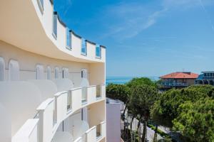 a building with a balcony with a view of the ocean at Hotel Schiller in Cervia