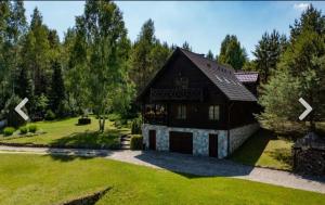 a house with a large yard with green grass at WILLA NAD STAWEM MAZURY in Piecki