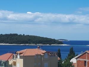 a view of the ocean and houses and buildings at Apartments Starshine & Lighthouse in Zečevo