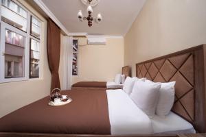 a bedroom with a large bed with white pillows at taxim cool in Istanbul
