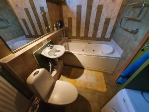 a bathroom with a toilet and a sink and a tub at Before reconstruction chance in Jūrmala +13 photos