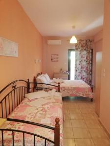 a room with two beds in a room with a window at House Anna Sarti in Sarti