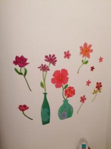 a wall with four vases with flowers on it at B&B RINGAT in Mori