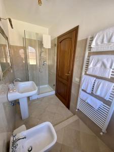 a bathroom with a sink and a shower and a mirror at Villa Silvana in Querceta