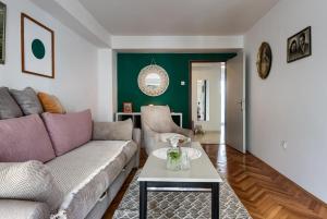 a living room with a couch and a table at Avocado apartment in Pula