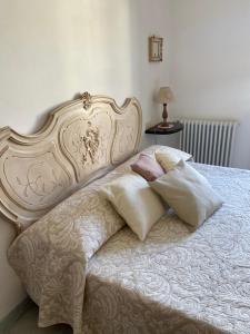 a bedroom with a white bed with pillows on it at Villa Silvana in Querceta