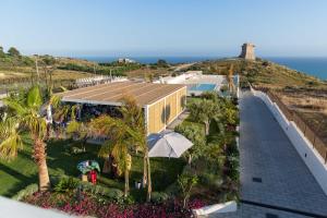 an aerial view of a house with the ocean in the background at Villa Aries - Rural Chic Experience in Gela