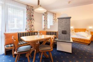 a hotel room with a table and a bed at Sporthotel Cristall in Fulpmes +70 photos