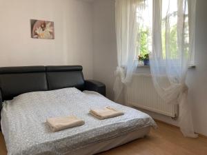 a bedroom with a bed with two towels on it at Dom Chotomów in Chotomów +12 photos