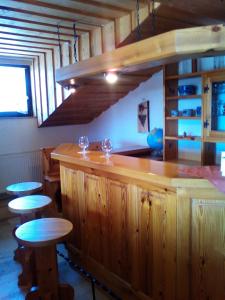 een keuken met een houten aanrecht met krukken en tafels bij Haus Alpenblick in Zenting
