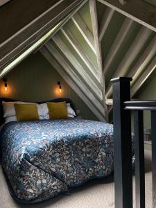 a bed in the attic of a room at The Crown Inn Dial Post in Horsham