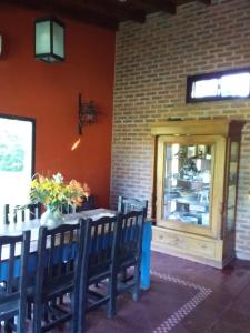 a dining room with a table and chairs and a window at Quinta en Mercedes in Mercedes