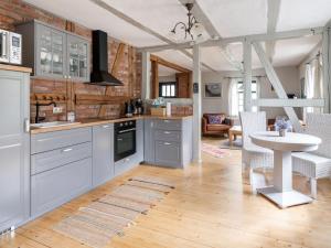 a kitchen with white cabinets and a table and chairs at Spacious Holiday Home in Landstorf Zierow with Beach Near in Zierow