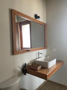 a bathroom with a sink and a mirror at Villas turrutela in Los Órganos