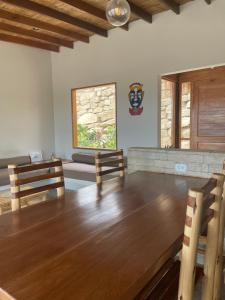 a dining room with a table and chairs and a window at Villas turrutela in Los Órganos