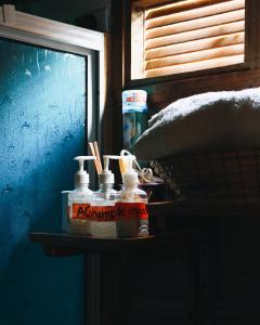 a table with two bottles of mouthwash and a tv at Cabañas Sinduly Bed & Breakfast in Sopó +36 photos