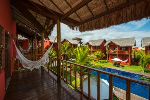 a view from the balcony of a resort with a hammock at Long Beach in Canoa Quebrada