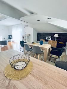 a living room with a table and chairs at SKY - beautiful rooftop apartment with shared pool in Split