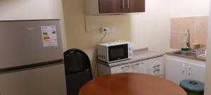 a small kitchen with a table and a microwave at Bellissa House in Antofagasta