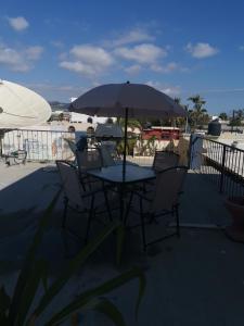 a table and chairs with an umbrella on a patio at Michelle's Place in Cabo San Lucas