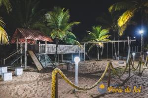 a playground on the beach at night at Pousada Porto do Sol in Nova Viçosa