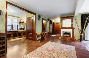 a living room with a fireplace and a kitchen at WILLA NAD STAWEM MAZURY in Piecki +19 photos