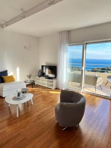 a living room with a bed and a large window at SKY - beautiful rooftop apartment with shared pool in Split