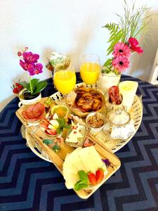 a table topped with plates of food and drinks at Esmaralda's Bed & Breakfast in Værløse