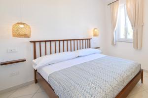 Säng eller sängar i ett rum på La Dimora Dei Nonni