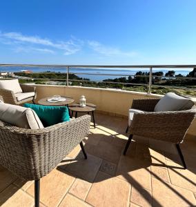 a patio with chairs and tables and a view of the ocean at SKY - beautiful rooftop apartment with shared pool in Split