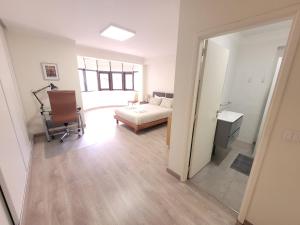 a living room with a couch and a desk and a chair at StaynFeel 03 in Fátima