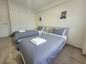 two beds in a room with two beds sidx sidx sidx sidx at StaynFeel 03 in Fátima