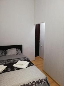 a bedroom with two beds with towels on them at Siemens House in Tbilisi City