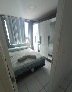 a bedroom with a bed and a large mirror at Apartamento Condominio Emilio Hinko - Beira Mar in Fortaleza