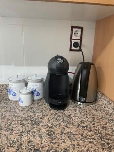 a kitchen counter with a coffee maker and a toaster at Apartament Comarques Catalanes in Móra d'Ebre