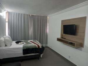 a bedroom with a bed with a cat laying on it at Apartamento 1011 in Goiânia +17 photos