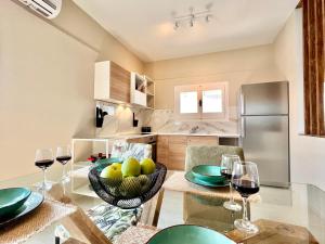 a kitchen and dining room with a table with glasses of wine at Elysian Studios in Roda