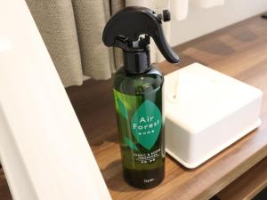 a green bottle of air forest soap sitting on a shelf at Tokyo Inn in Tokyo