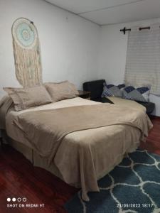 a bedroom with a bed with a headboard at La Baquiana in Mercedes