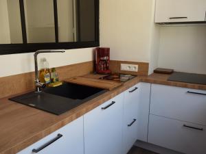 a kitchen with white cabinets and a sink at Maison 3 étoiles au centre des Sables d'Olonne avec accès plage, Wifi et garage - FR-1-197-519 in Les Sables-dʼOlonne +28 photos
