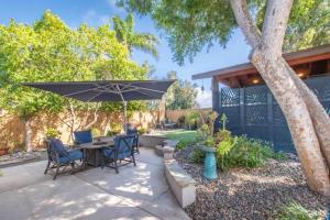 a patio with a table and chairs and an umbrella at Spacious, Luxury Ocean Master Suite 2 BD With Kitchenette in San Diego