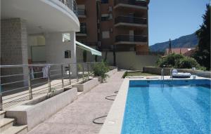a swimming pool in front of a building at 1 Bedroom Nice Apartment In Kotor in Kotor