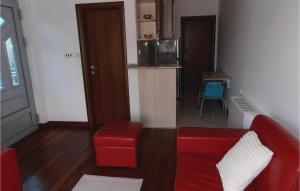 a living room with a red couch and a chair at 1 Bedroom Nice Apartment In Kotor in Kotor