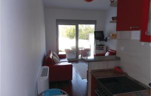 a kitchen and living room with a couch and a window at 1 Bedroom Nice Apartment In Kotor in Kotor