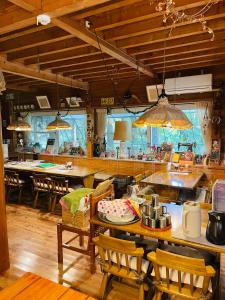 a dining room with tables and chairs in a restaurant at Sanrinsha in Takamori