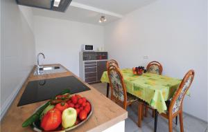 a kitchen with a table with a plate of fruit on it at 4 Bedroom Beautiful Home In Crni Kal in Črni Kal +12 photos