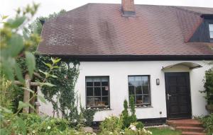 a white house with a brown roof at Awesome Home In Sassnitz With Kitchen in Sassnitz