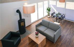 a living room with a couch and a wood stove at Ferienhaus 2 Wolfschlucht in Gondenbrett